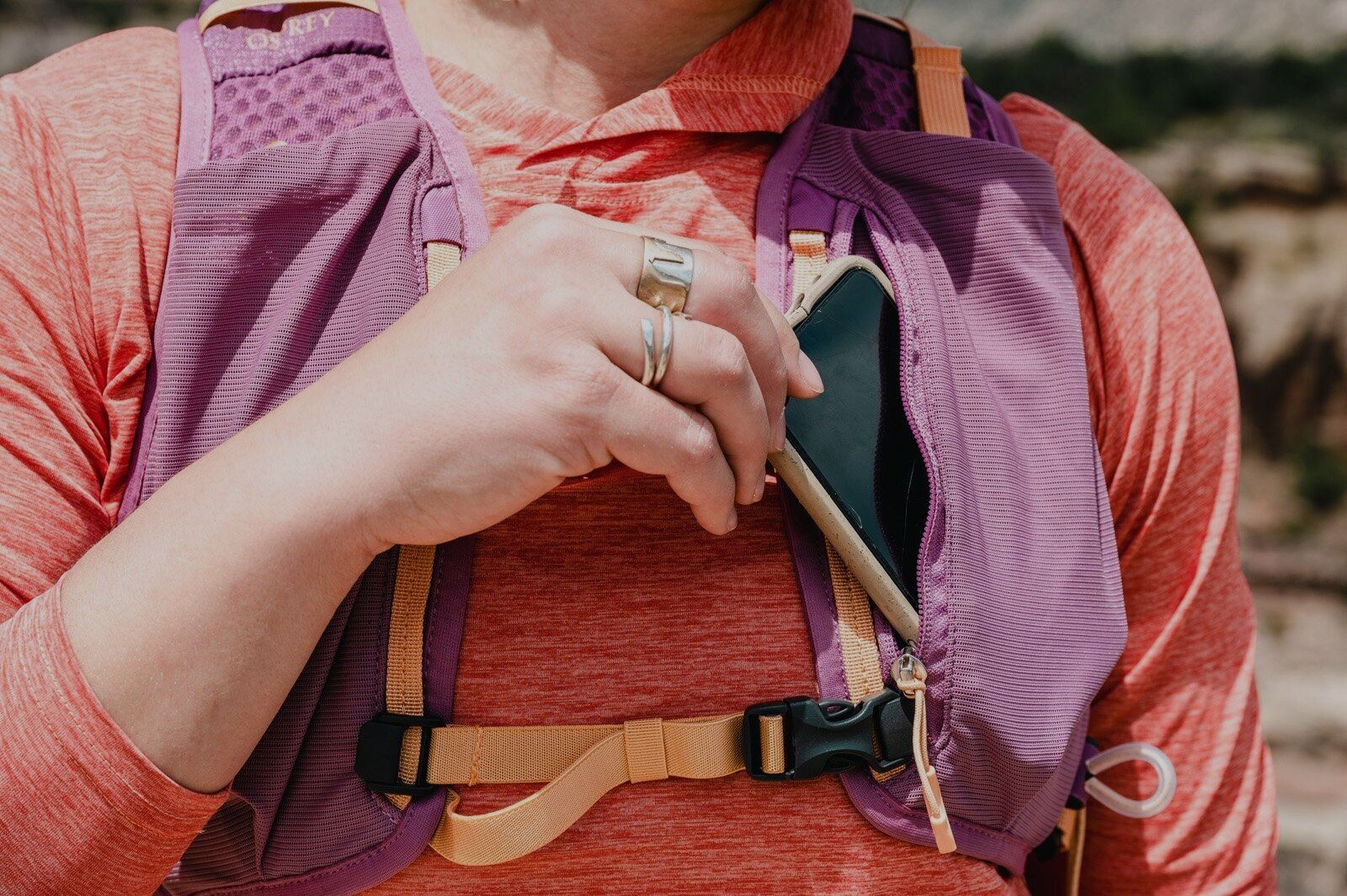 Accessing phone pocket on shoulder strap of Osprey Tempest Velocity 30 hiking daypack