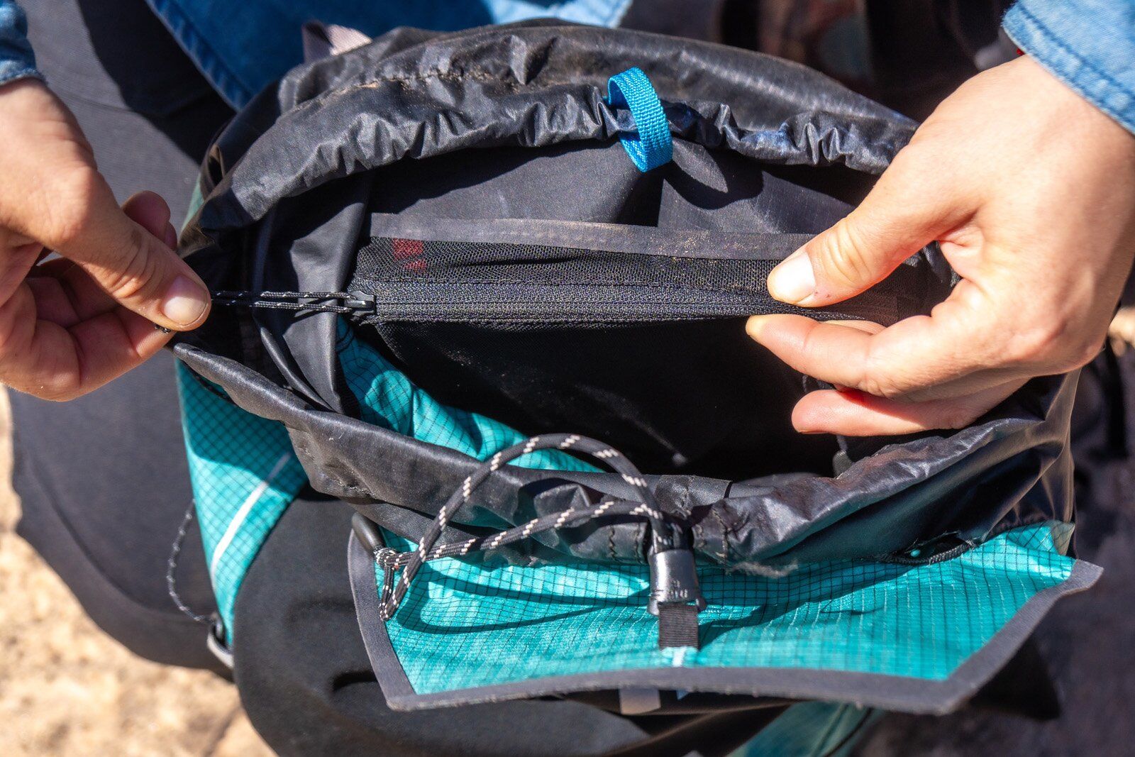 Accessing zipper side compartment in the Black Diamond Distance 22 hiking daypack