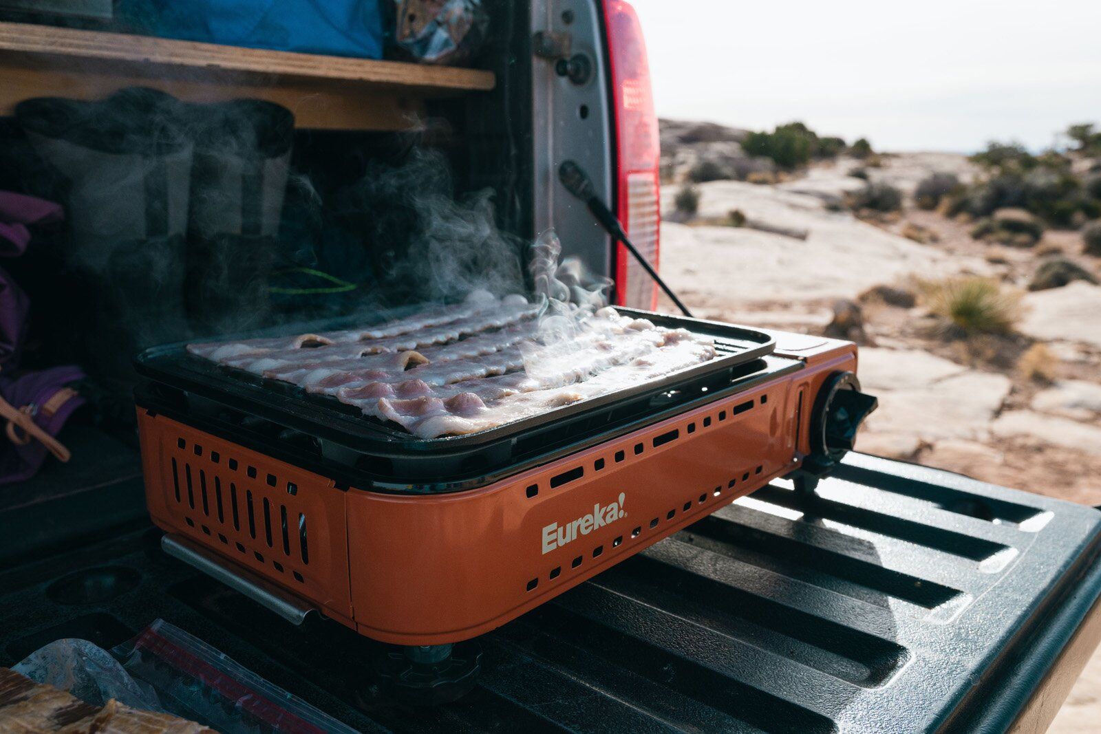 Bacon cooking on the Eureka SPRK camping stove