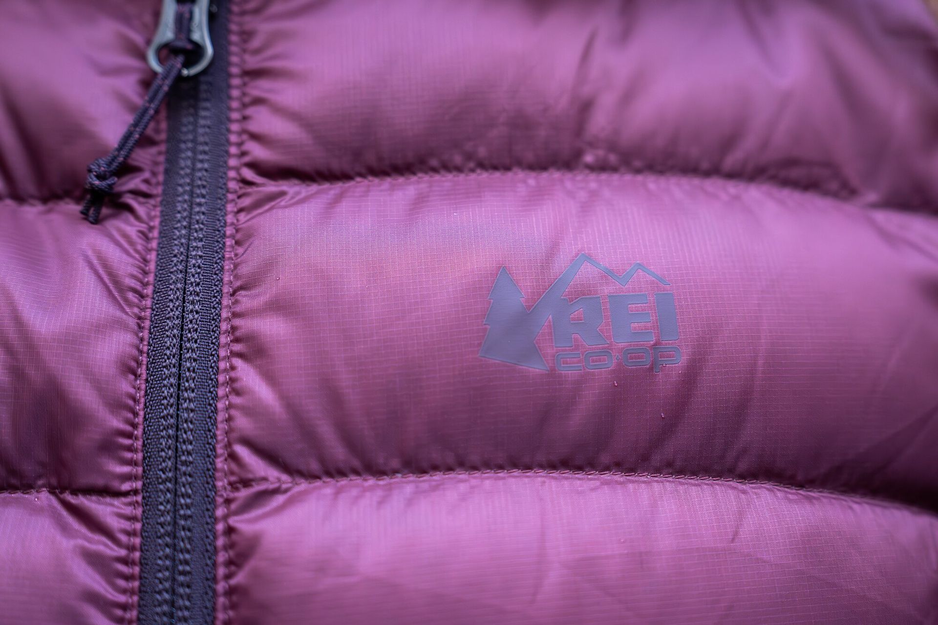 Baffle and logo close-up of REI Co-op 650 down jacket.