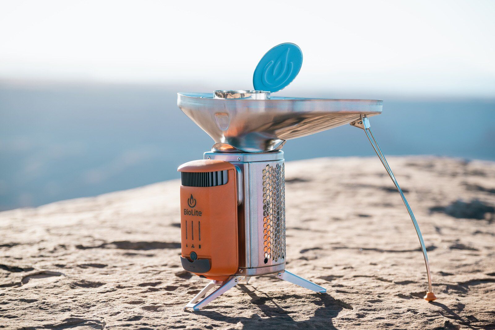 BioLite CampStove 2+ camping stove set up on a rock for cooking