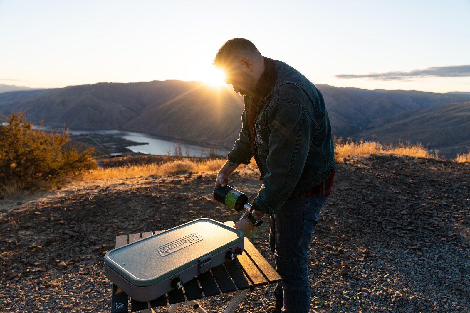 Camper setting up the Coleman Cascade 3-in-1 camping stove