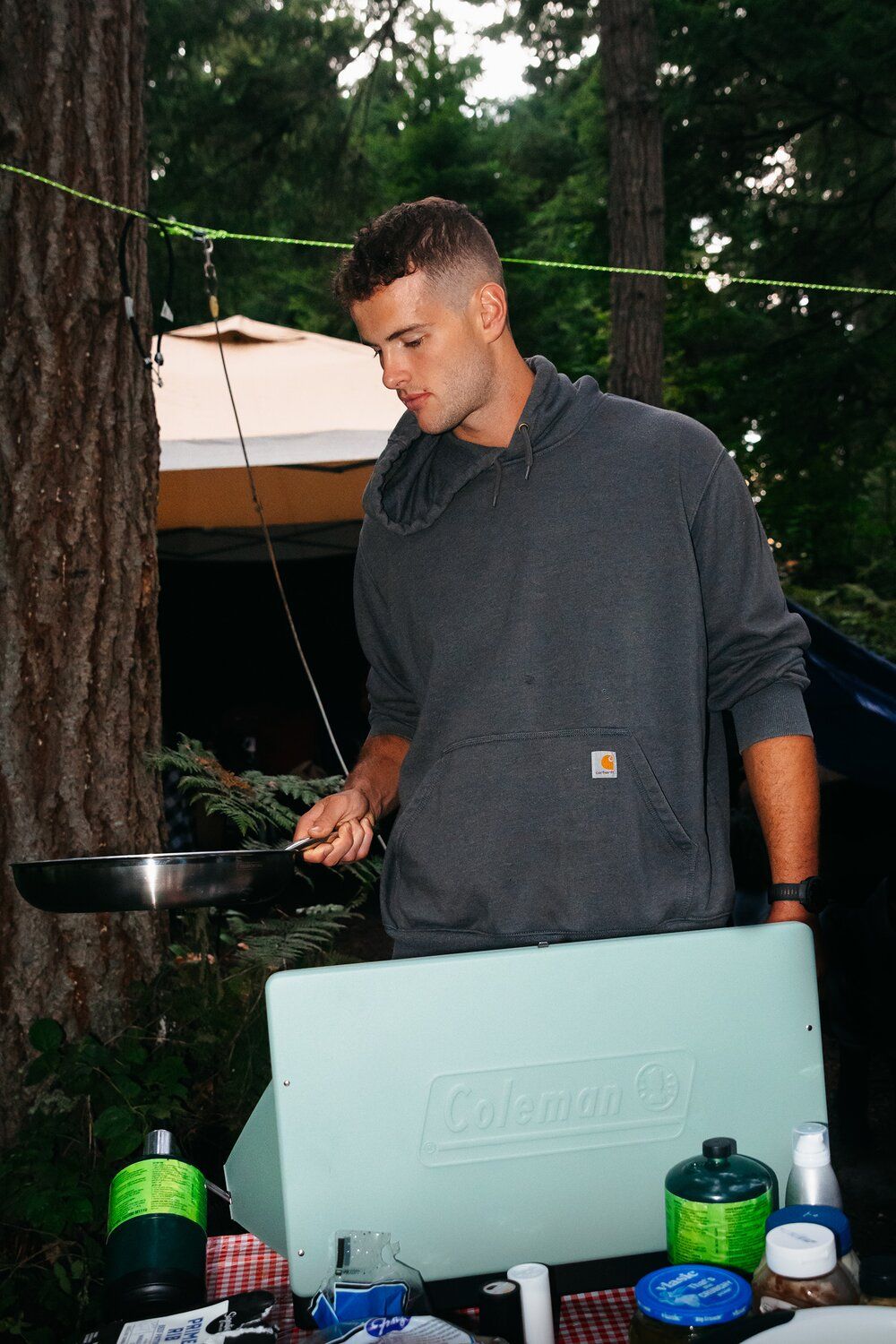 Camper using the Coleman Cascade Classic camping stove