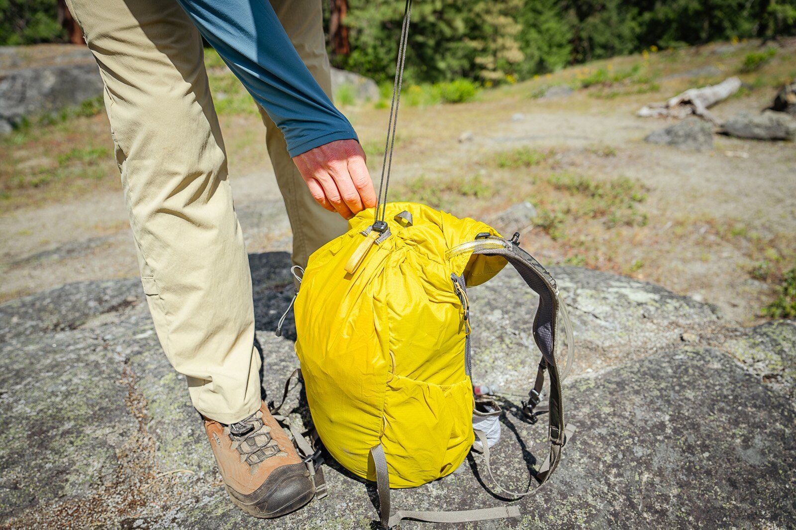 Cinching main compartment closed of REI Co-op Flash 22 hiking daypack