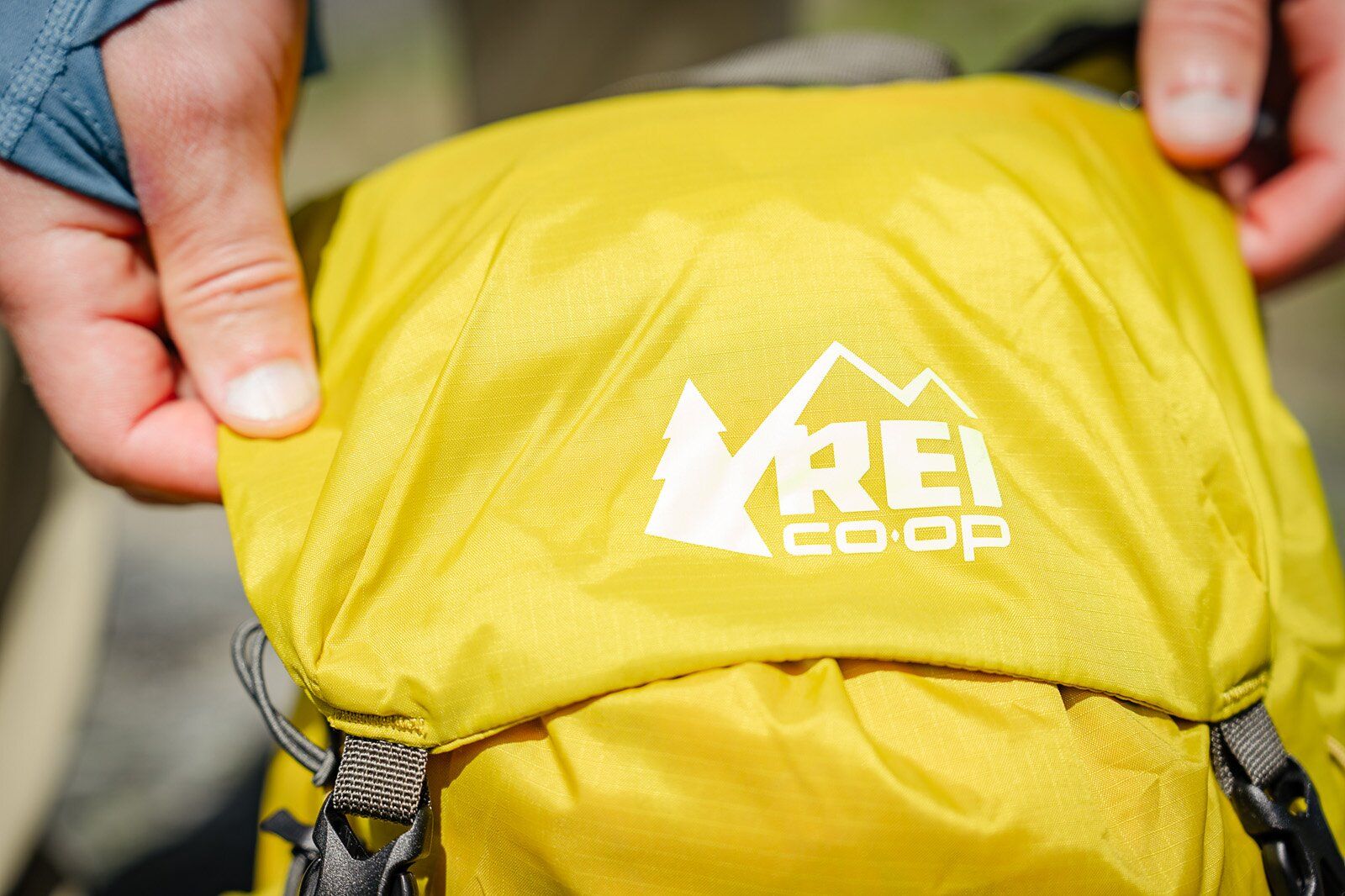 Close-up of REI logo on top panel of REI Co-op Flash 22 hiking daypack