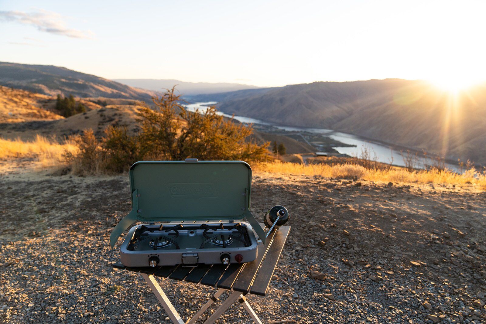 Coleman Cascade 3-in-1 camping stove set up on camp table