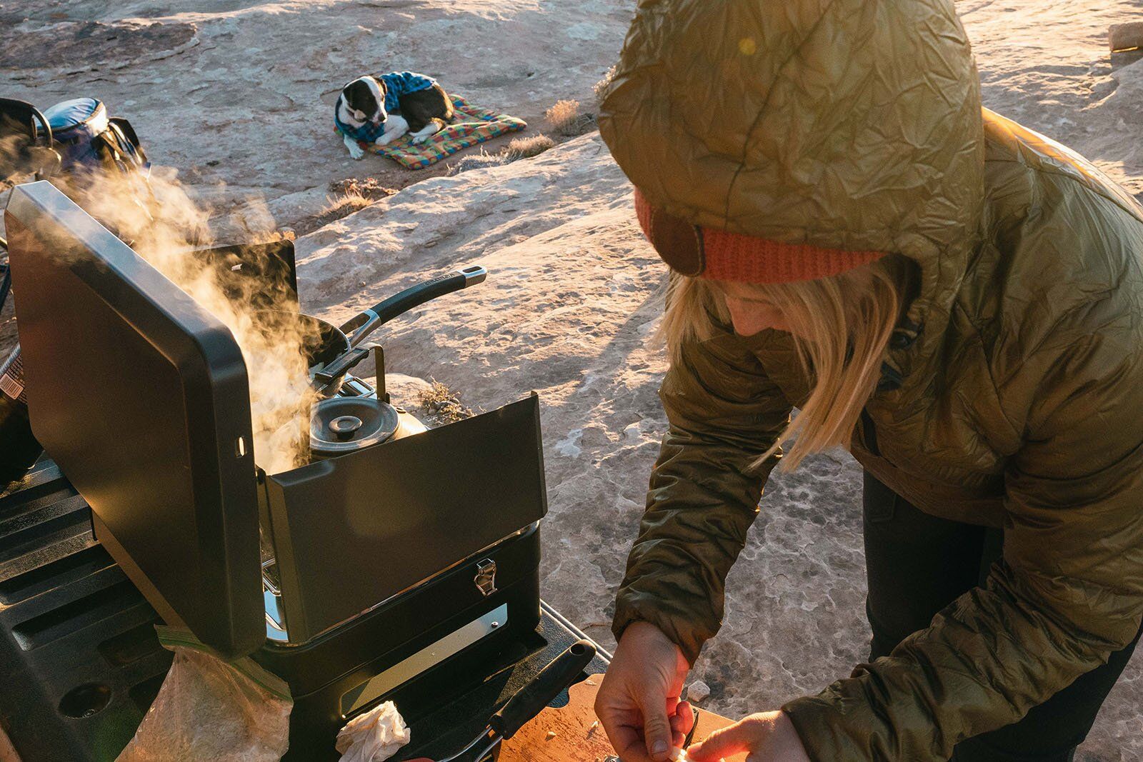 Cooking on camping stove at sunrise