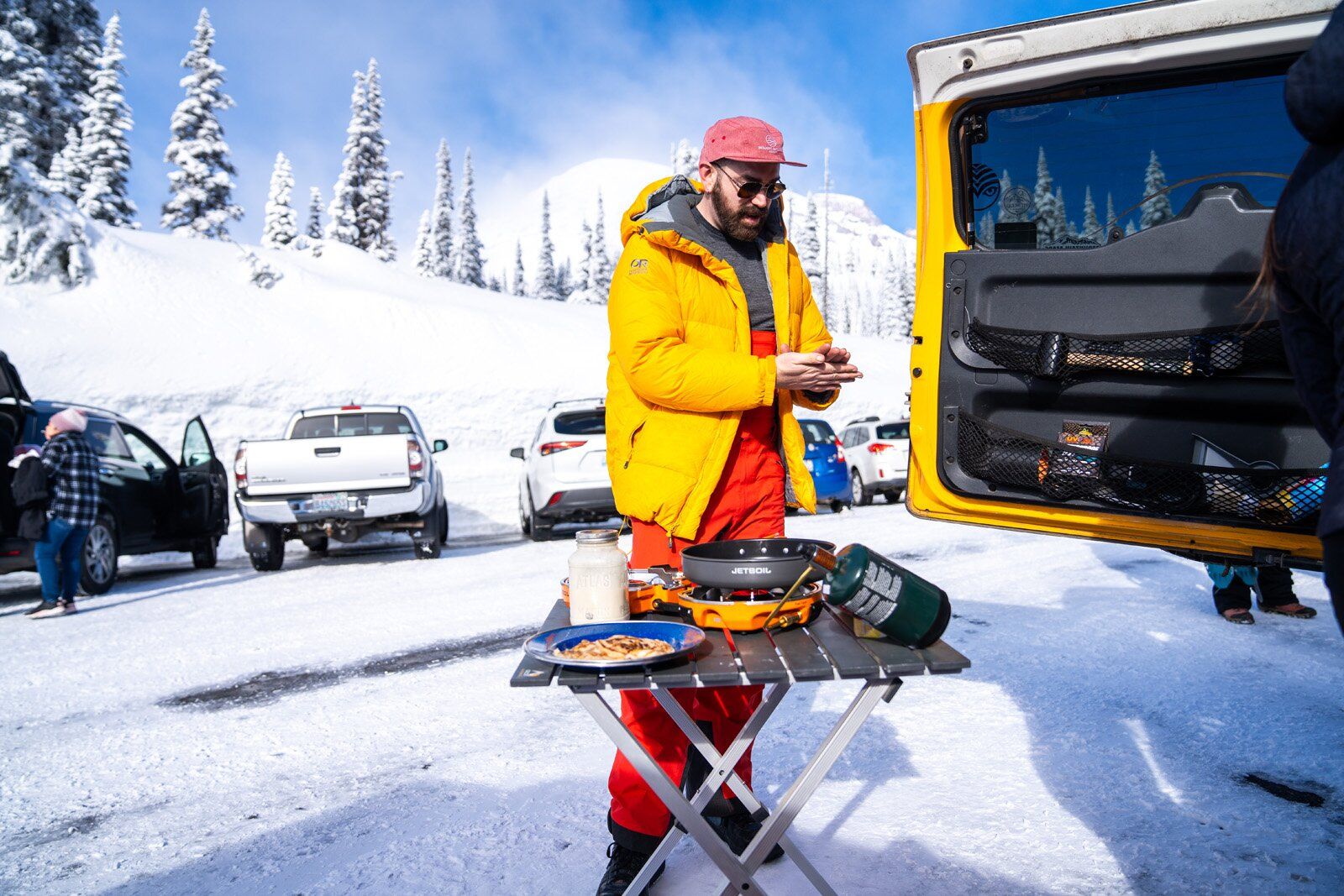 Cooking with Jetboil Genesis Basecamp System camping stove in the ski lot