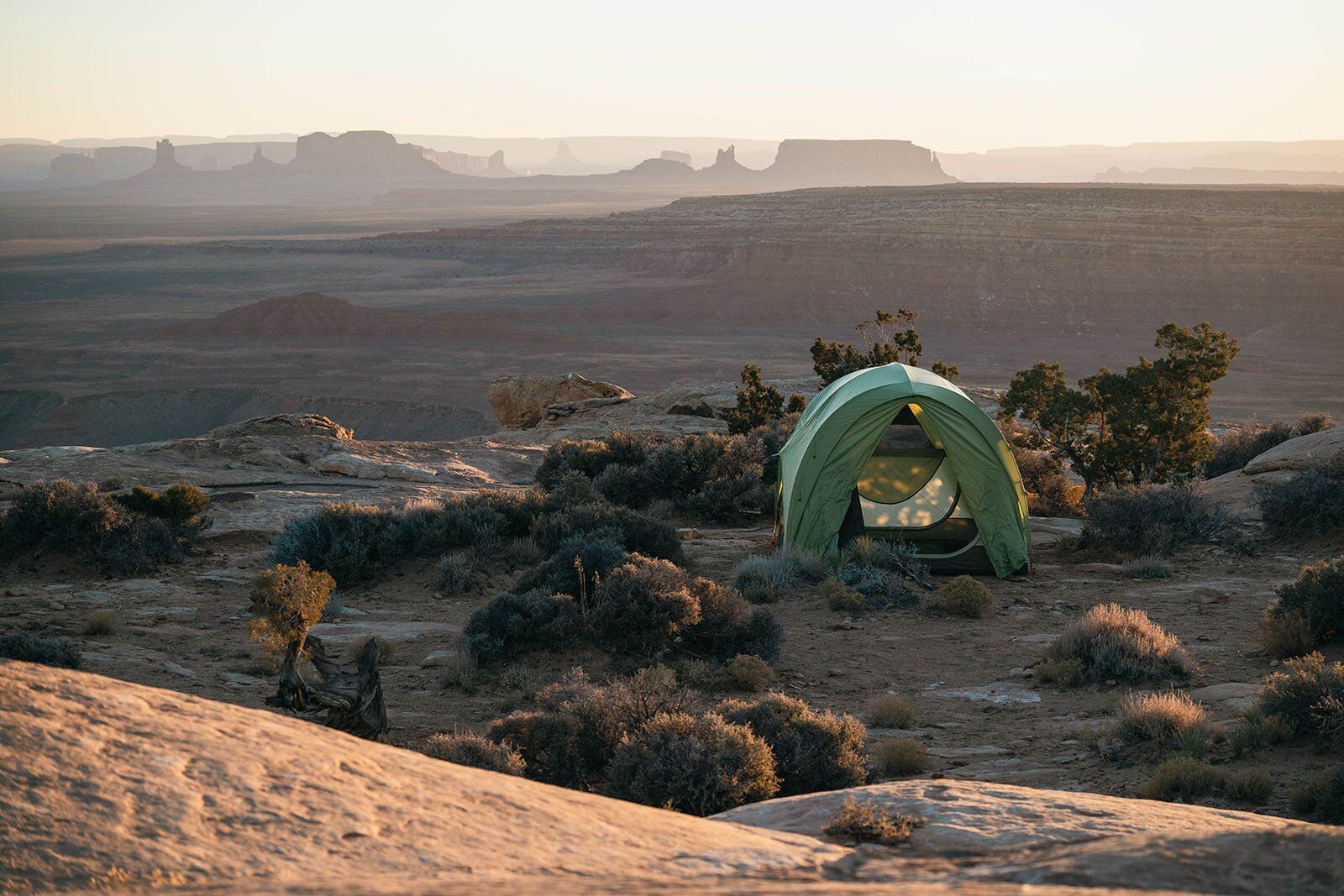 Desert skyline at sunrise with tent
