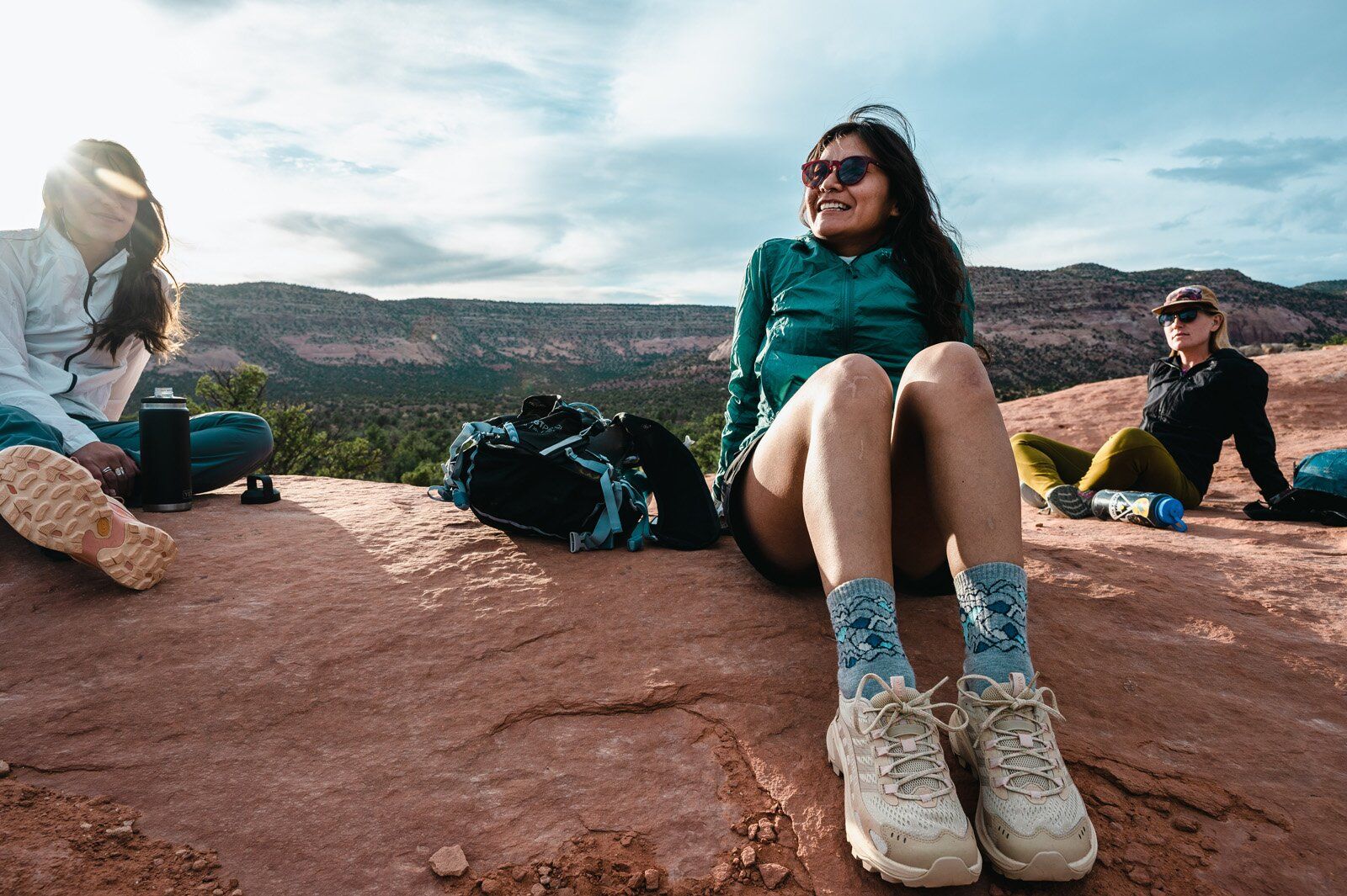 Hiker resting with Ultimate Direction Fastpack 20 hiking daypack nearby