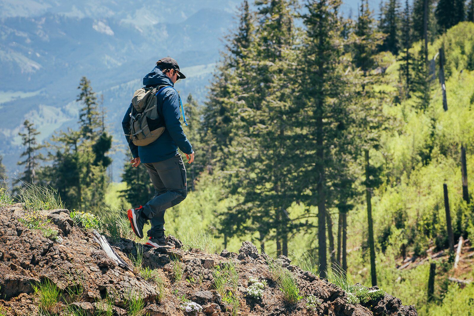 Hiking down trail wearing the Mystery Ranch Gallagator 25 hiking daypack