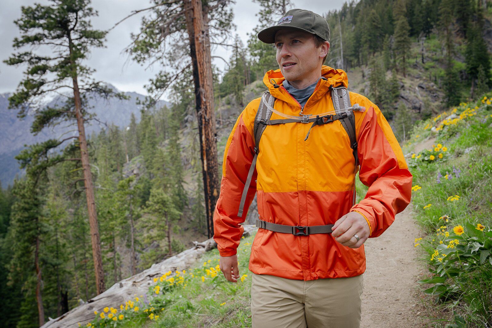 Hiking down trail wearing the REI Co-op Flash 22 hiking daypack
