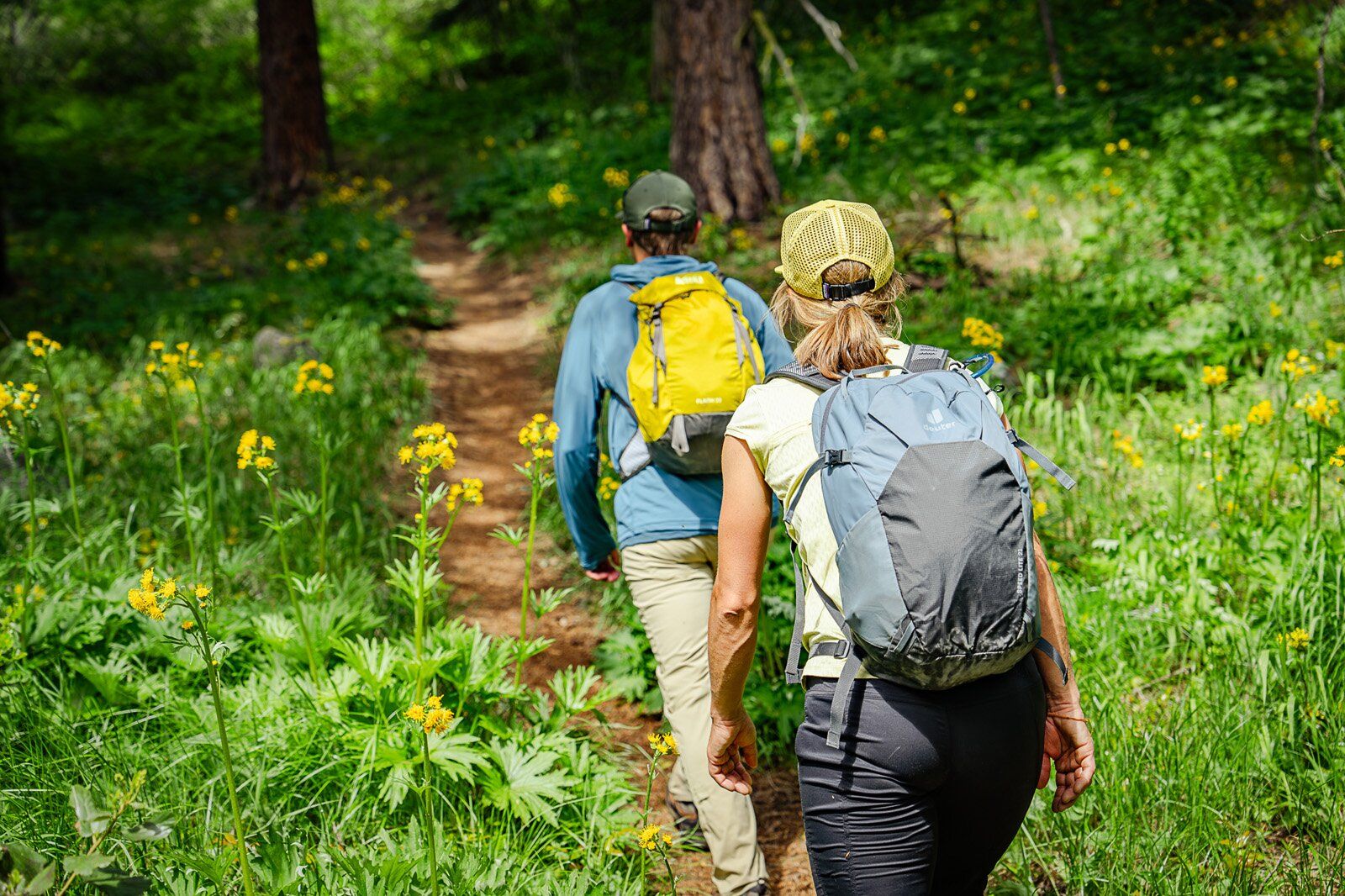 Hiking up forest trail with the REI Co-op Flash 22 hiking daypack