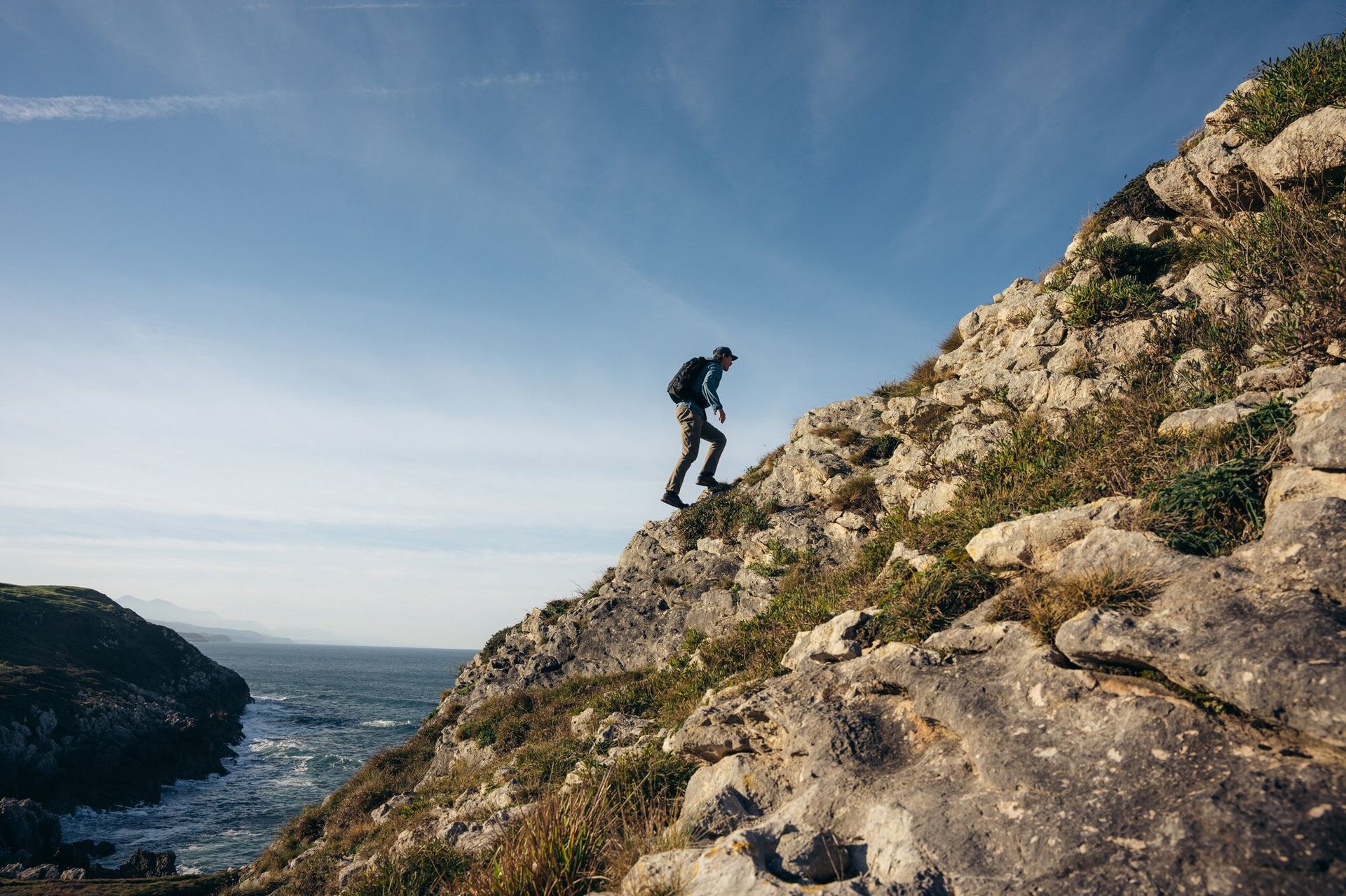 Hiking up rocky trail wearing the Osprey Talon 22 hiking daypack