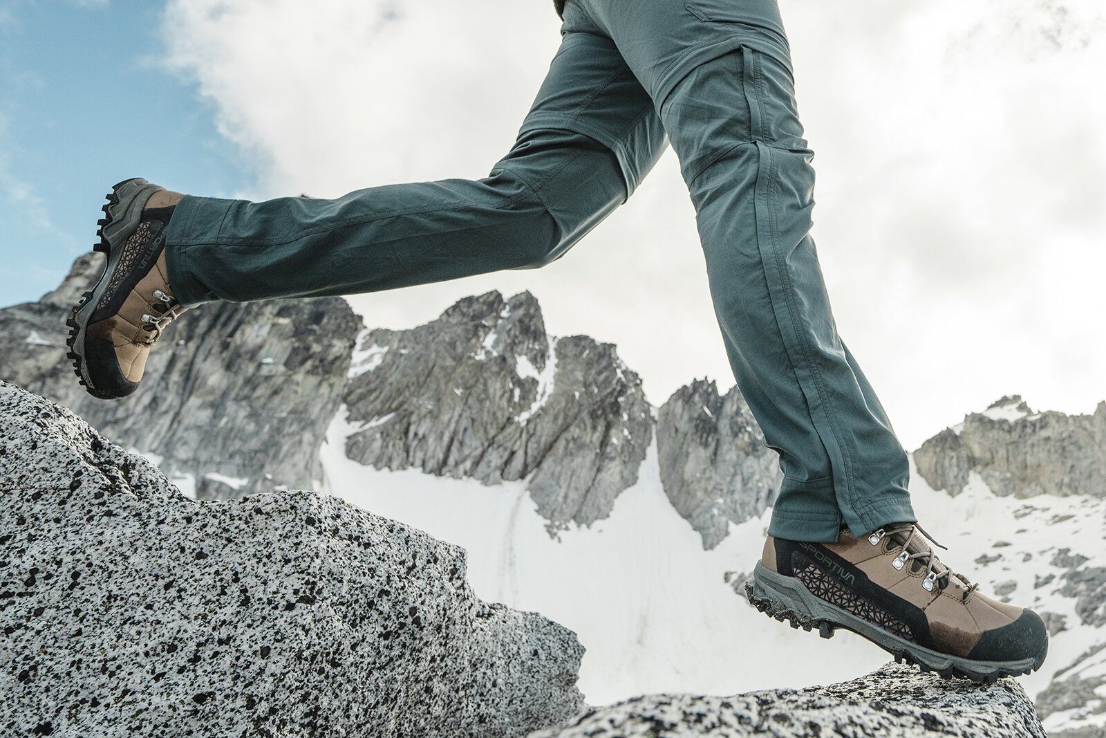 La Sportiva Nucleo High II GTX stepping down onto rock in mountains.jpg