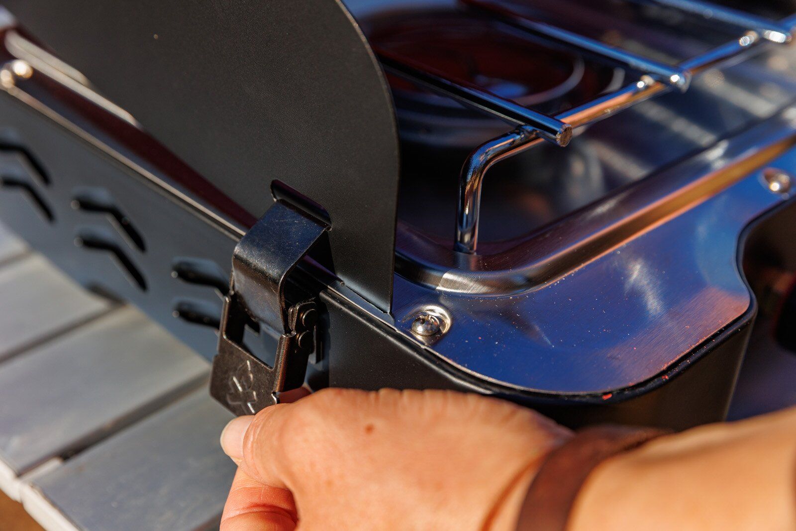 Locking wind guard into place on the Camp Chef Everest 2X camping stove