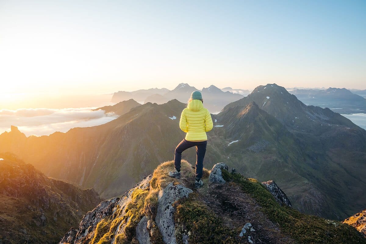 Looking out over Lofoten landscape wearing Arc'teryx Cerium Hoody and Salomon Quest hiking boots mobile