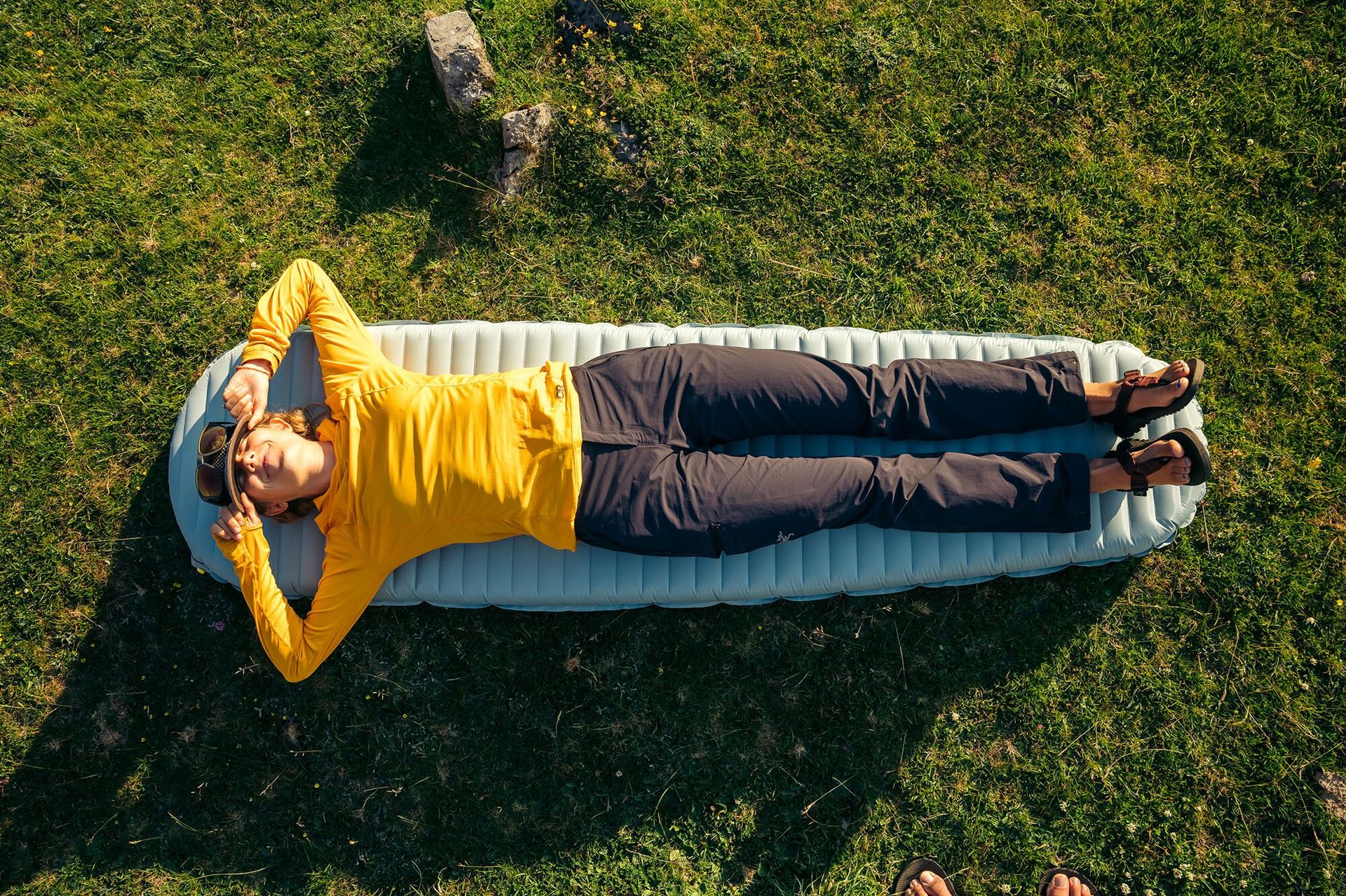 Lying on sleeping pad wearing the Outdoor Reseach Echo Hoody base layer