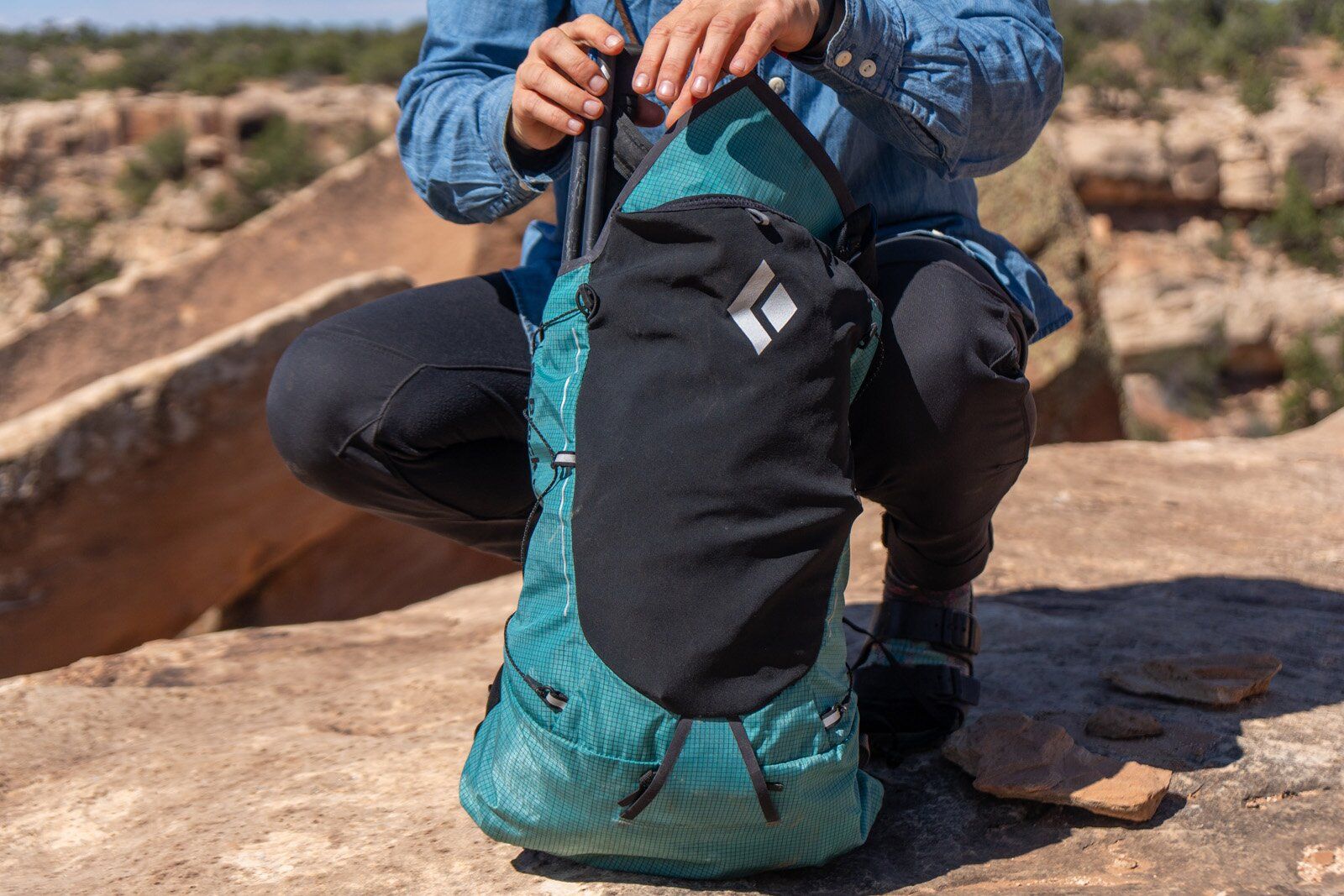 Packing gear into main compartment of Black Diamond Distance 22 hiking daypack