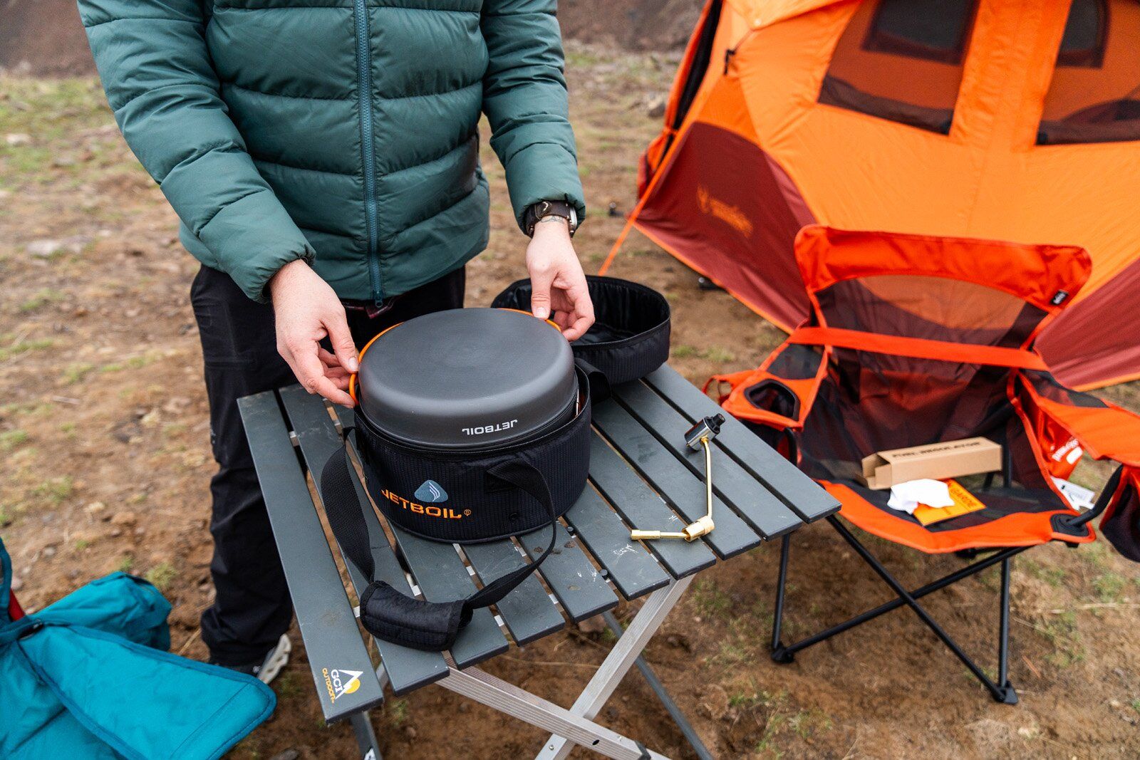 Pulling out Jetboil Genesis Basecamp System camping stove from bag