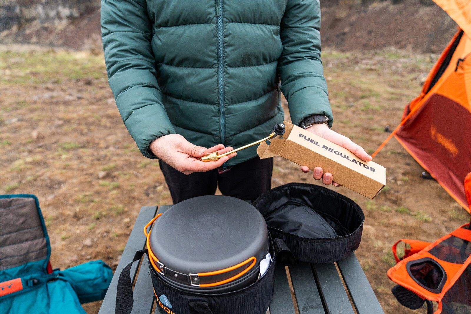Pulling out Jetboil Genesis Basecamp System camping stove fuel regulator