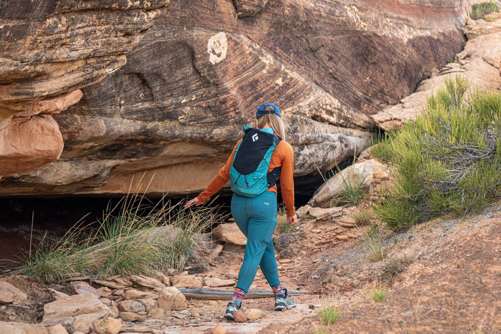 Rear view of hiker on rock trail with Black Diamond Distance 22 hiking daypack