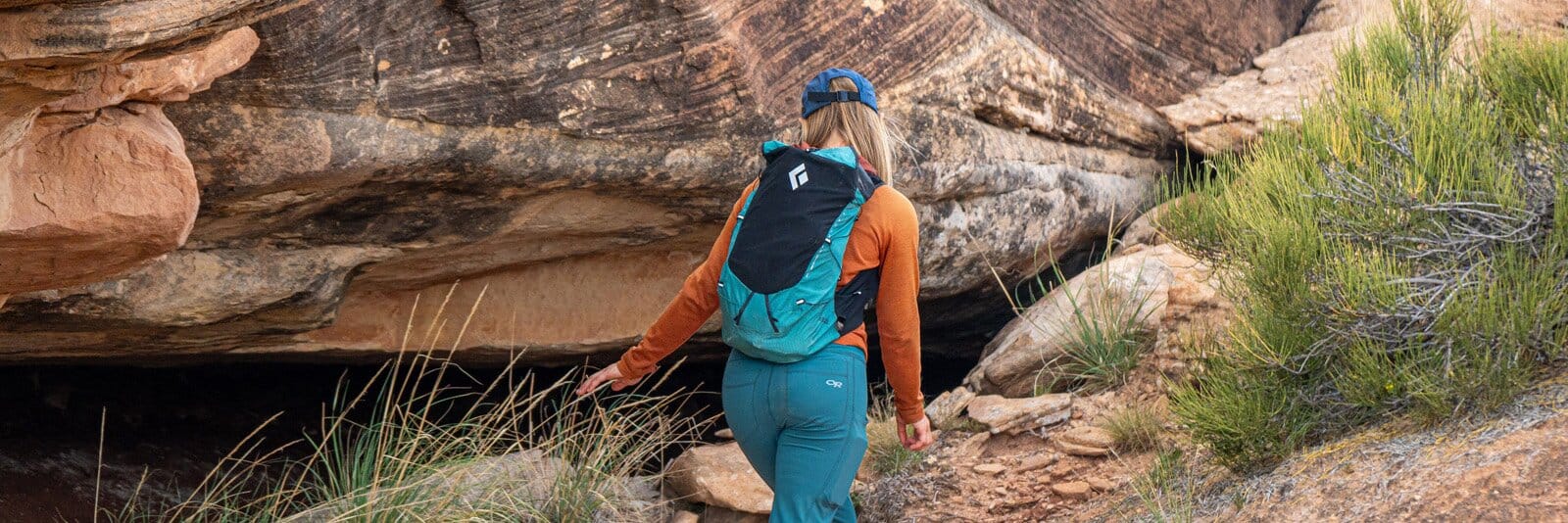 Rear view of hiker on rock trail with Black Diamond Distance 22 hiking daypack