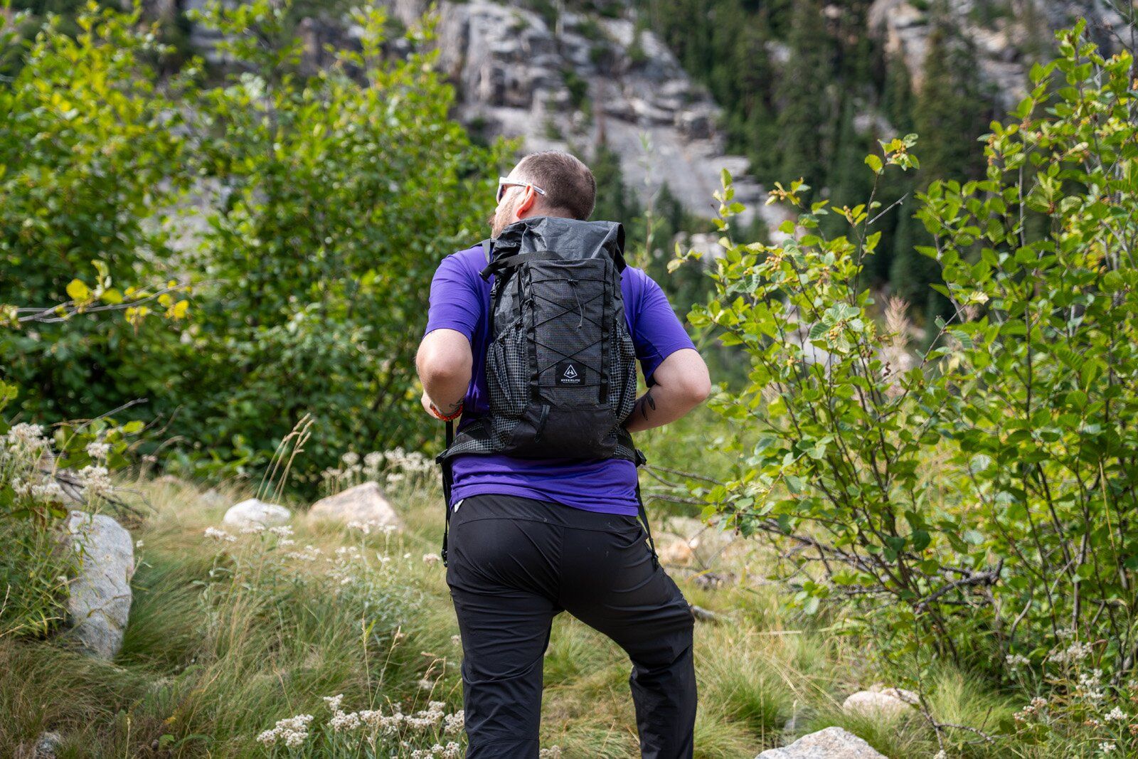 Rear view of hiker wearing Hyperlite Mountain Gear Elevate 22 hiking daypack