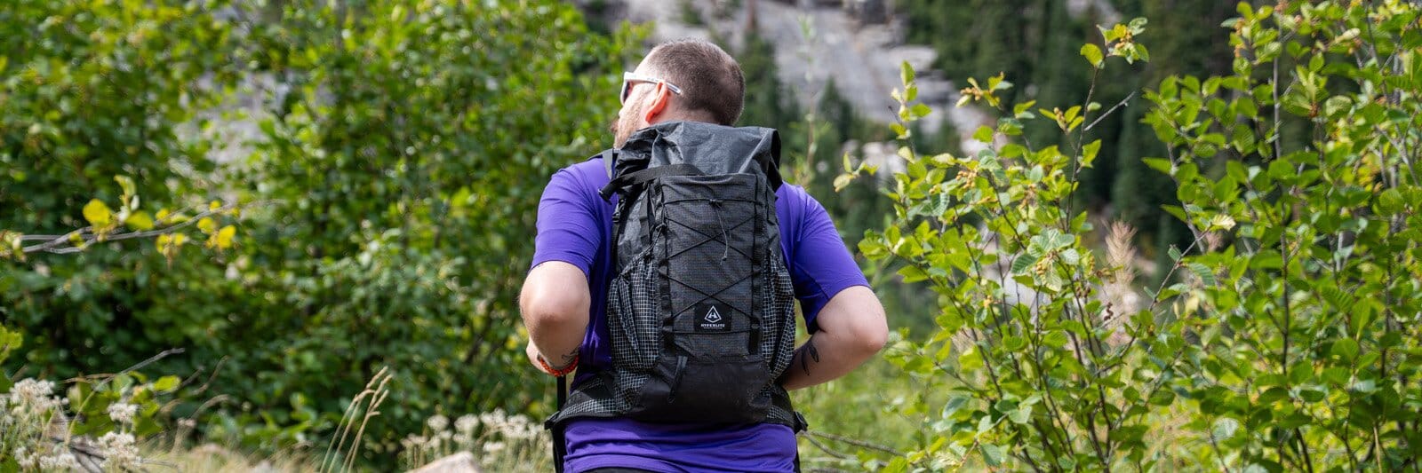 Rear view of hiker wearing Hyperlite Mountain Gear Elevate 22 hiking daypack