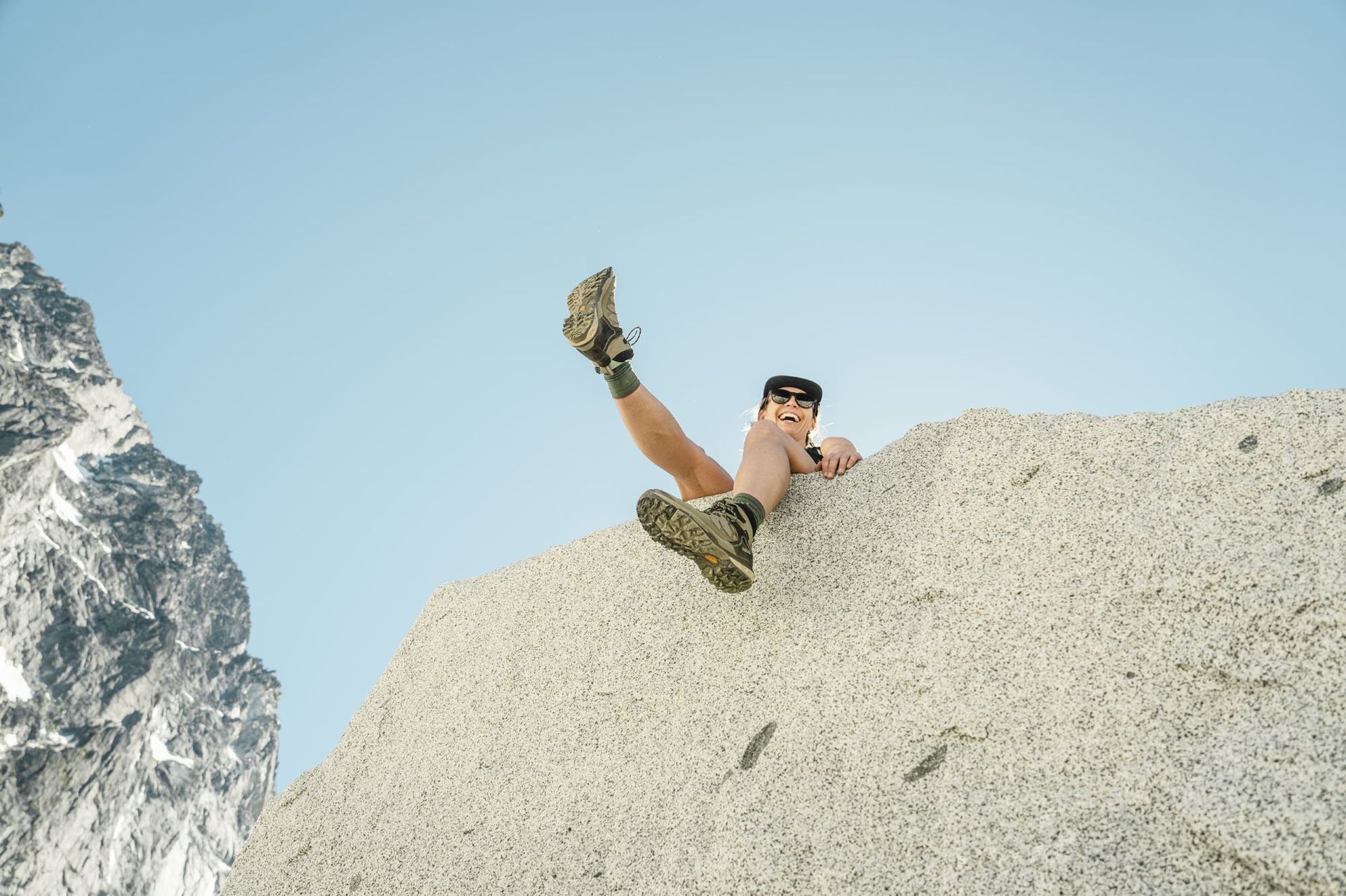 Sitting on a large boulder wearing the Asolo Falcon GV Evo hiking boots