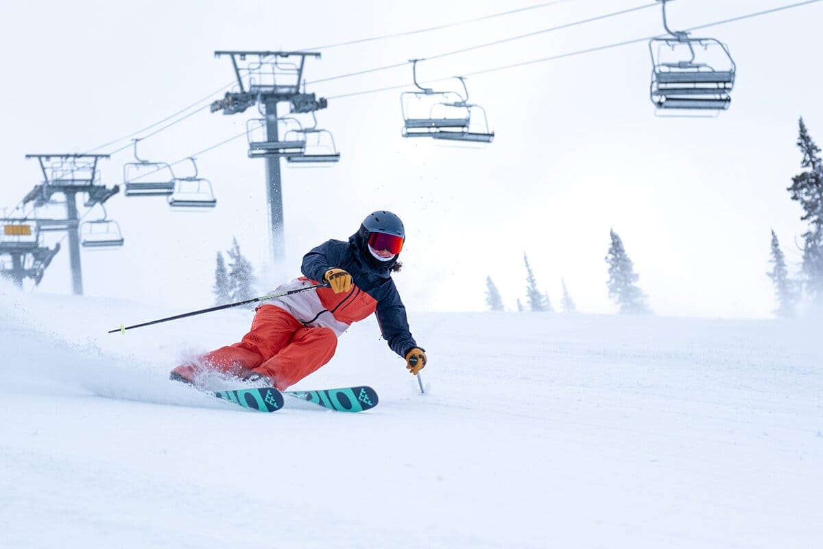 Skiing groomer near chairlift wearing Flylow Lucy ski jacket