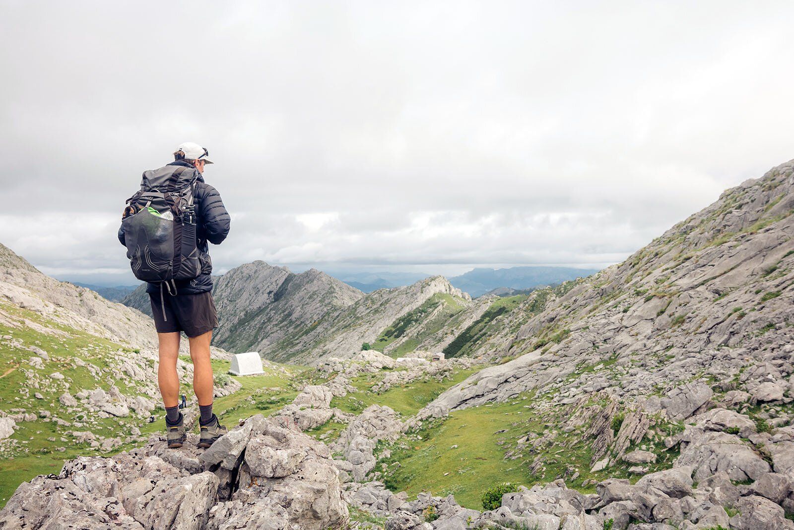Staring at landscape wearing the Osprey Exos 58 backpacking pack