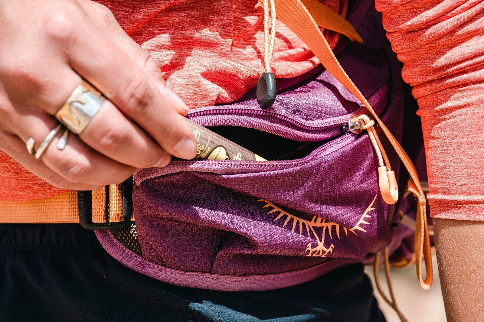Storing chapstick in hip belt pocket of Osprey Tempest Velocity 30 hiking daypack