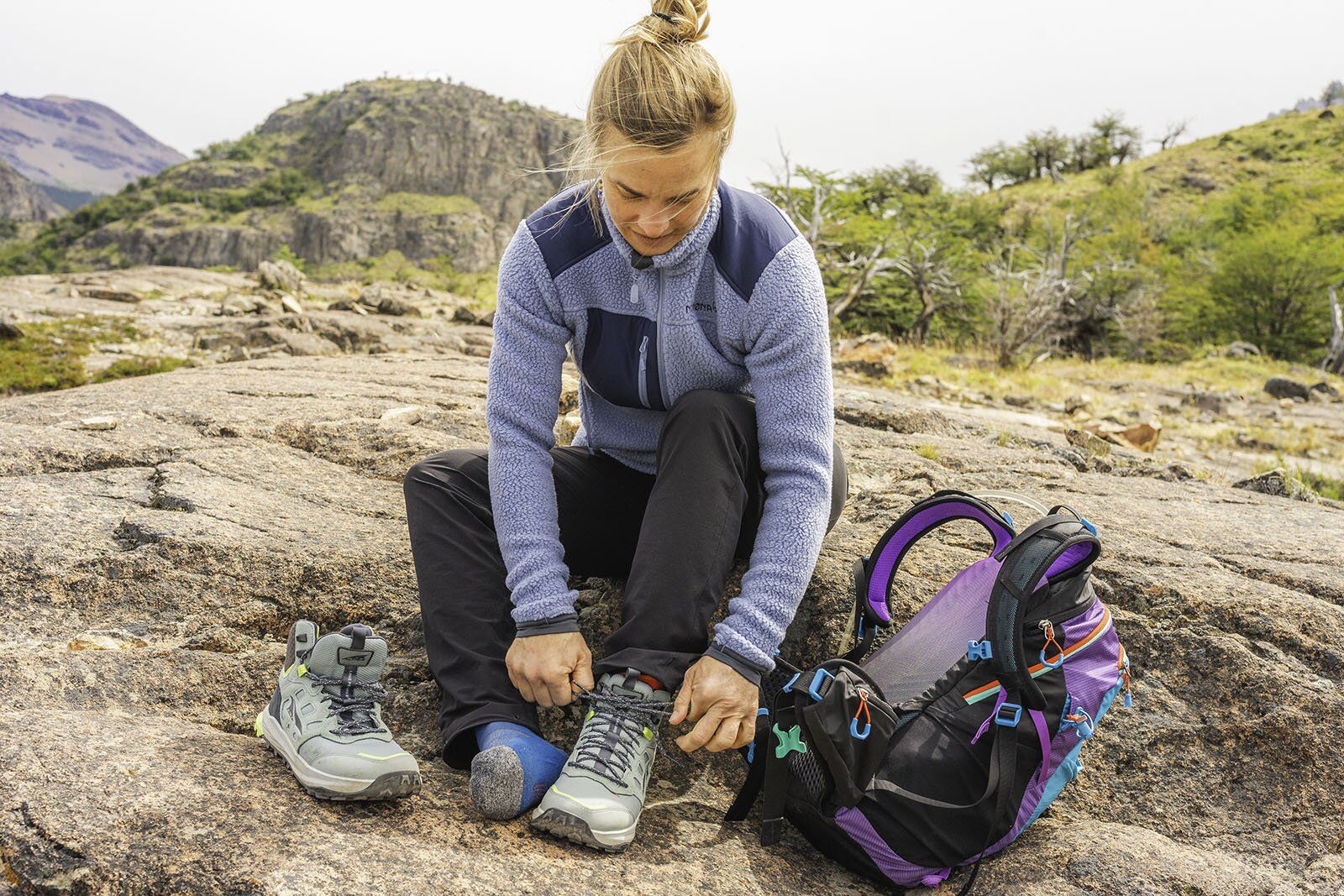 Tying hiking boot next to Gregory Maya 20 daypack