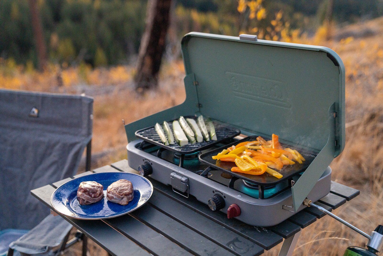 Veggies cooking on Coleman Cascade 3-in-1 camping stove grill and griddle