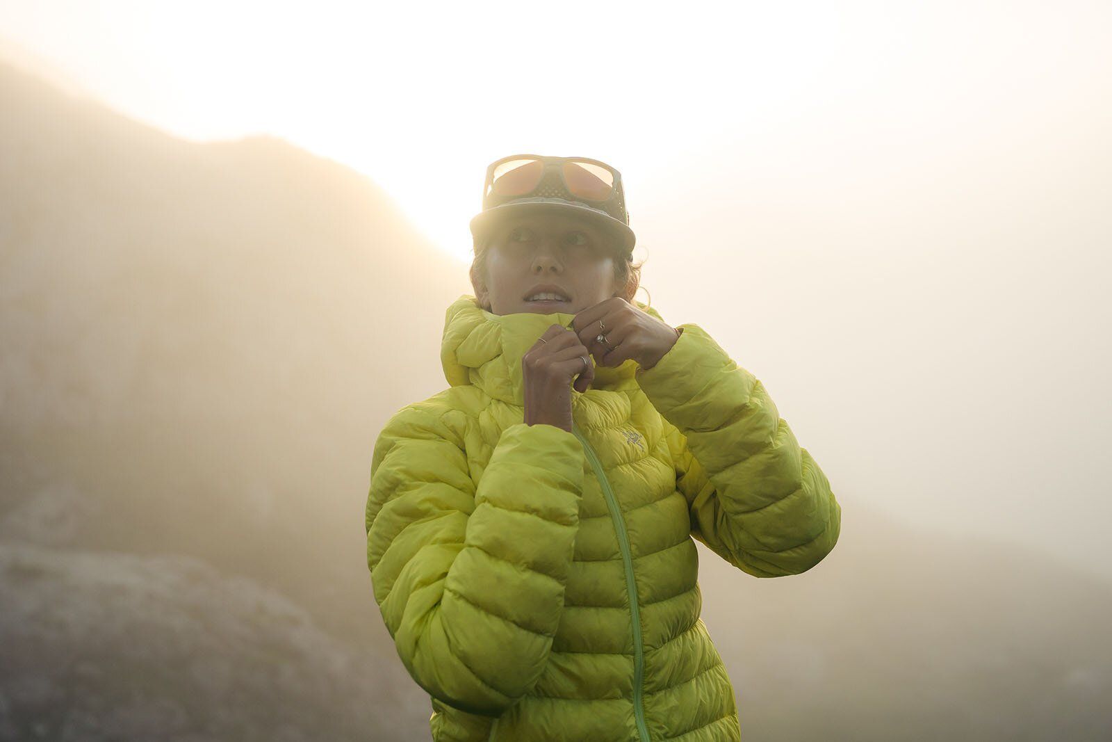 Wearing the Arc'teryx Cerium Hoody down jacket during foggy sunset