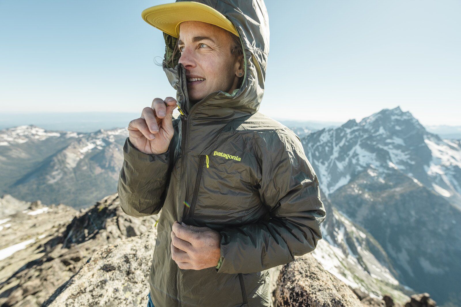 Zipping up Patagonia DAS Light Hoody synthetic insulated jacket with hood up